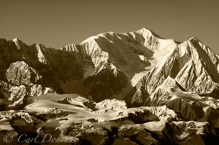 Late afternoon light strikes Mt. Bona - black and white photo.