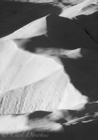 Black and white photo of snow covered moraine on the Root Glacier, Kennecott, winter, Wrangell-St. Elias National Park, Alaska.